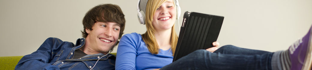 Man Women Labtop relaxing on Sofa - UTStarcom